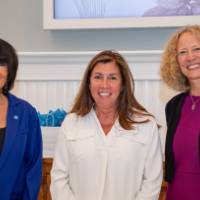 Faculty smiling with president and provost after recognition